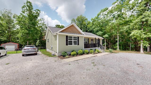 785 Grindstone Hollow Rd, Dickson, TN 37055 - view of front facade featuring crawl space, covered porch, an outbuilding, and gravel driveway