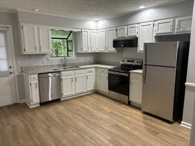 3332 Oak Trees Ct, Antioch, TN 37013 - kitchen with stainless steel appliances, crown molding, light wood-type flooring, white cabinetry, and recessed lighting