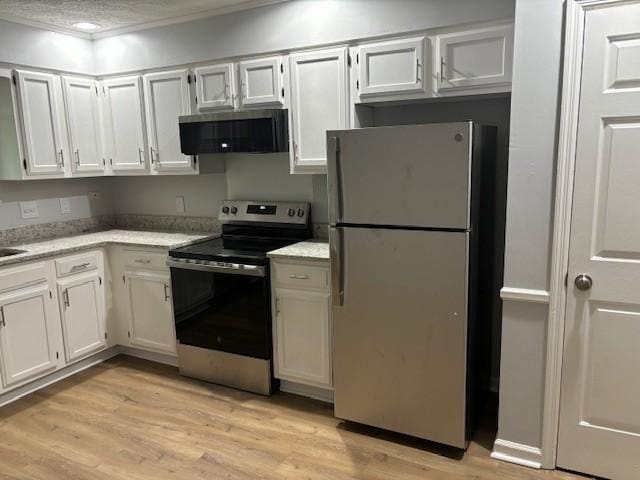 3332 Oak Trees Ct, Antioch, TN 37013 - kitchen featuring appliances with stainless steel finishes, extractor fan, light wood-type flooring, ornamental molding, and white cabinetry