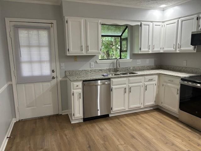 3332 Oak Trees Ct, Antioch, TN 37013 - kitchen featuring appliances with stainless steel finishes, ornamental molding, light wood-style floors, white cabinetry, and light stone countertops