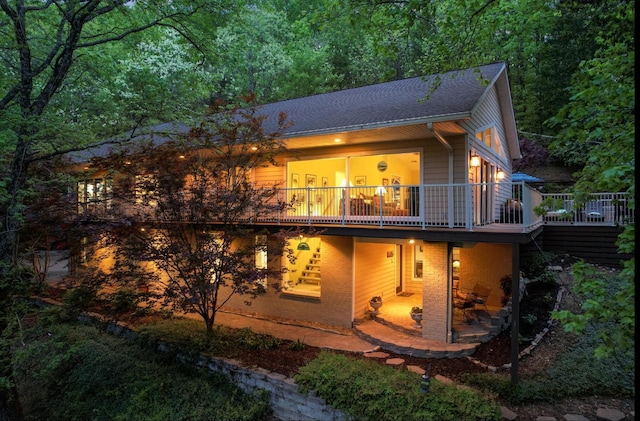 6607 Ormond Dr, Nashville, TN 37205 - view of front facade with a wooden deck, roof with shingles, and a patio
