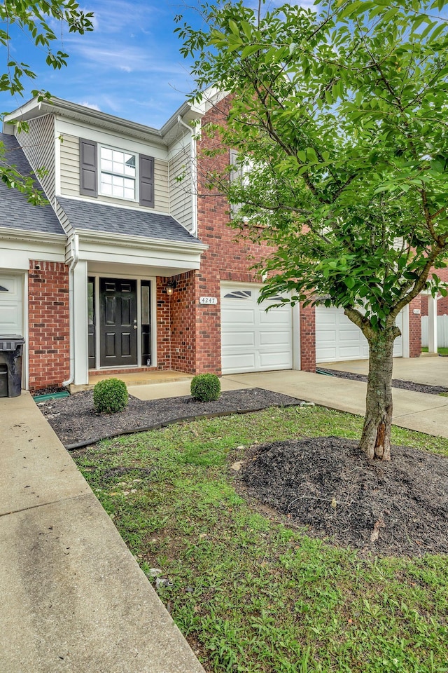 4247 Aurora Cir, Murfreesboro, TN 37127 - view of front facade featuring concrete driveway, an attached garage, brick siding, and a shingled roof