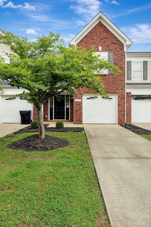 4247 Aurora Cir, Murfreesboro, TN 37127 - view of front of property with driveway, brick siding, and a garage