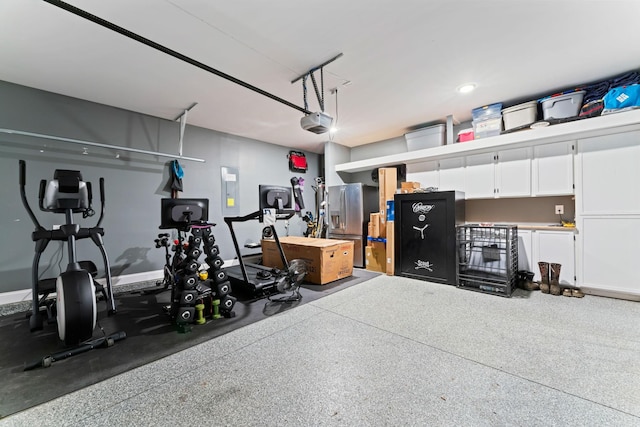 2529 Precast Dr, Columbia, TN 38401 - garage with stainless steel fridge, a garage door opener, and electric panel