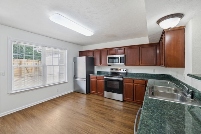 354 Arapaho Dr, Murfreesboro, TN 37128 - kitchen with stainless steel appliances, dark countertops, dark wood finished floors, and a textured ceiling