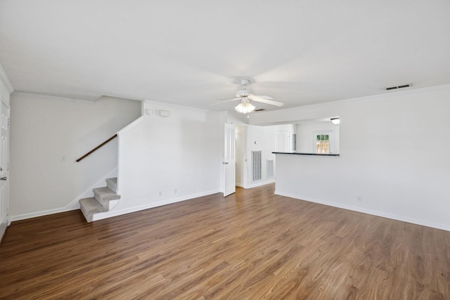 354 Arapaho Dr, Murfreesboro, TN 37128 - unfurnished living room with wood finished floors, ornamental molding, a ceiling fan, and stairway