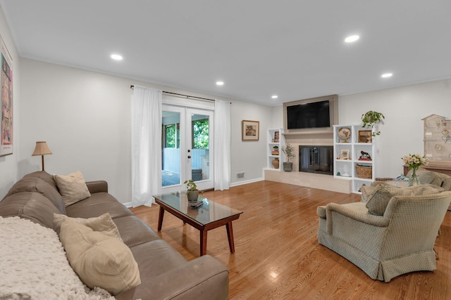 106 Dellrose Dr, Nashville, TN 37214 - living room featuring recessed lighting, light wood finished floors, a glass covered fireplace, and french doors