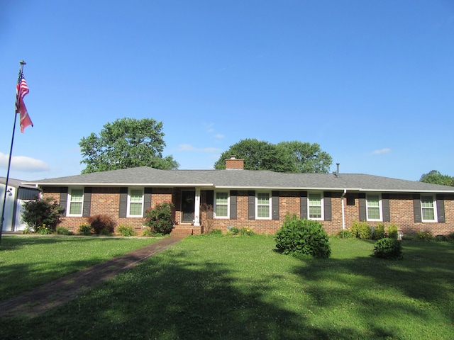 136 Houghton Dr, Winchester, TN 37398 - ranch-style home with brick siding, a front lawn, and a chimney
