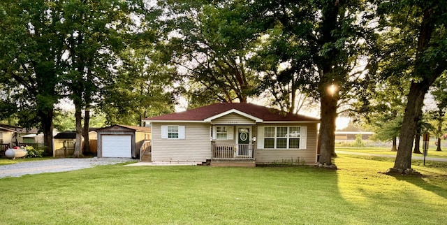 30429 Sims St, Ardmore, TN 38449 - view of front facade with an outdoor structure, driveway, a front yard, and a detached garage