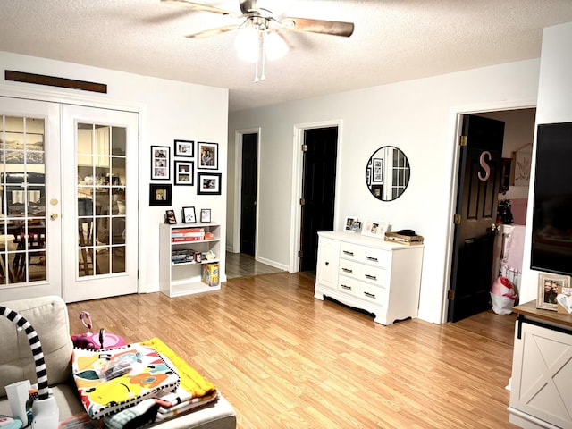 30429 Sims St, Ardmore, TN 38449 - living area featuring ceiling fan, light wood-style flooring, and a textured ceiling