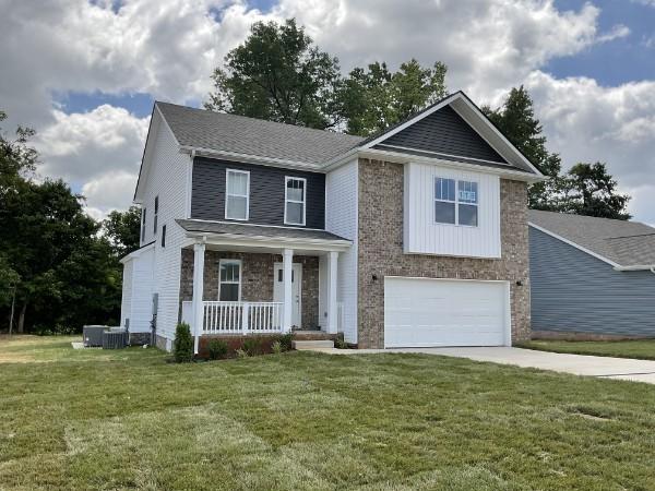 1209 Elizabeth Ln, Clarksville, TN 37042 - view of front of property featuring covered porch, concrete driveway, a garage, and a front lawn