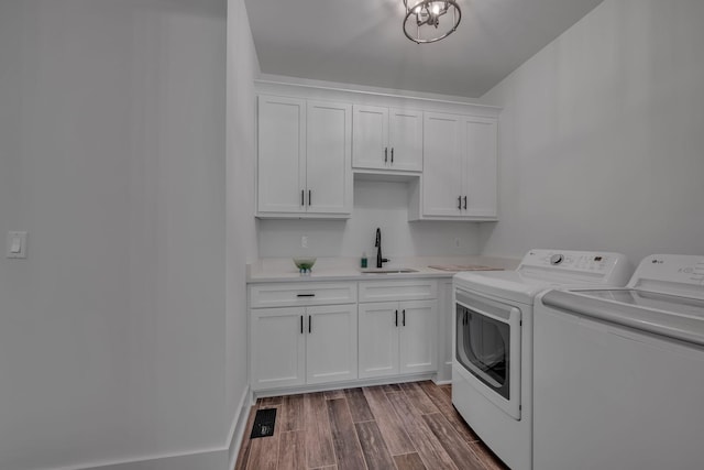 445 Old Pond Ln, Dickson, TN 37055 - laundry room featuring washer and dryer, dark wood-type flooring, and cabinet space