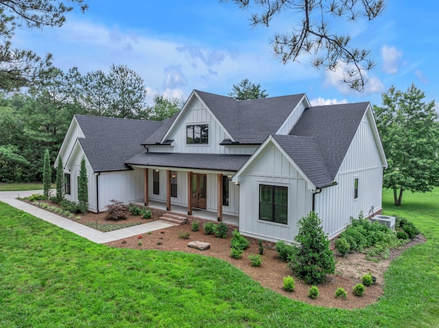 445 Old Pond Ln, Dickson, TN 37055 - modern farmhouse style home with a shingled roof, a porch, a front yard, and board and batten siding