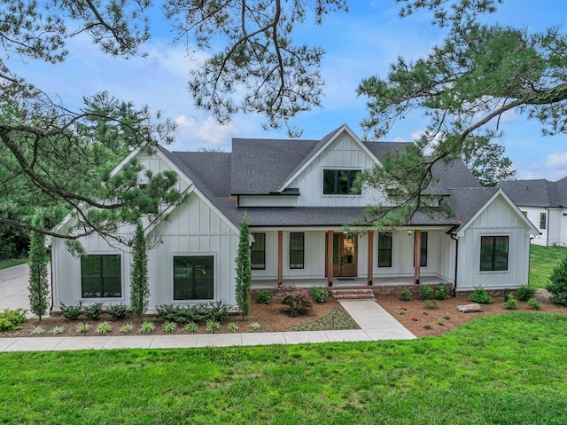445 Old Pond Ln, Dickson, TN 37055 - modern farmhouse style home with a shingled roof, board and batten siding, a porch, and a front yard