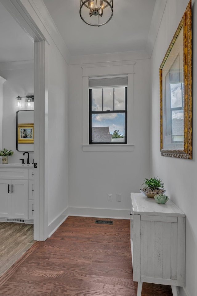 445 Old Pond Ln, Dickson, TN 37055 - corridor with crown molding, wood finished floors, and a chandelier