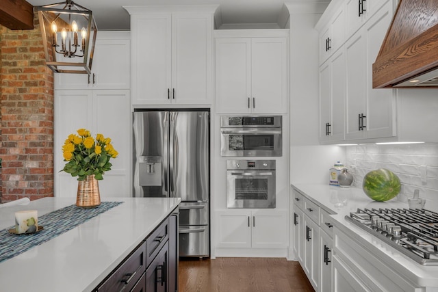445 Old Pond Ln, Dickson, TN 37055 - kitchen featuring stainless steel appliances, custom range hood, a chandelier, light countertops, and white cabinets
