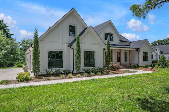 445 Old Pond Ln, Dickson, TN 37055 - modern inspired farmhouse with board and batten siding, a front lawn, driveway, and a shingled roof