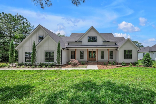 445 Old Pond Ln, Dickson, TN 37055 - modern farmhouse featuring board and batten siding, covered porch, a front lawn, and roof with shingles