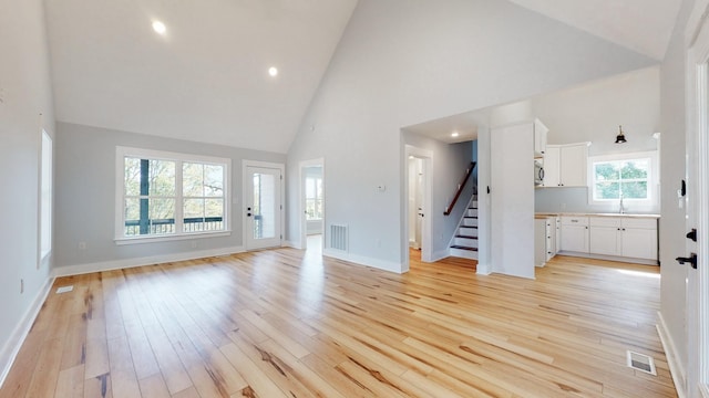 2346 Rhea Branch Rd, Ethridge, TN 38456 - unfurnished living room with high vaulted ceiling, stairway, light wood-style floors, and recessed lighting