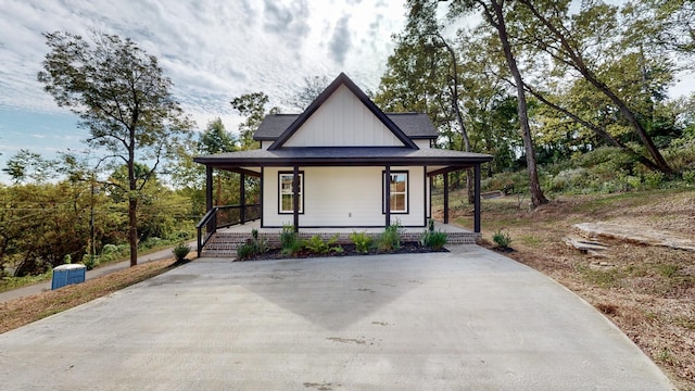 2346 Rhea Branch Rd, Ethridge, TN 38456 - modern farmhouse style home featuring board and batten siding, a porch, and concrete driveway