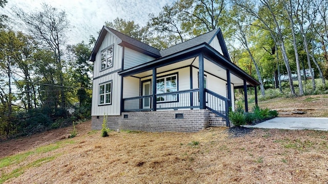 2346 Rhea Branch Rd, Ethridge, TN 38456 - view of front of house featuring covered porch, board and batten siding, crawl space, and roof with shingles