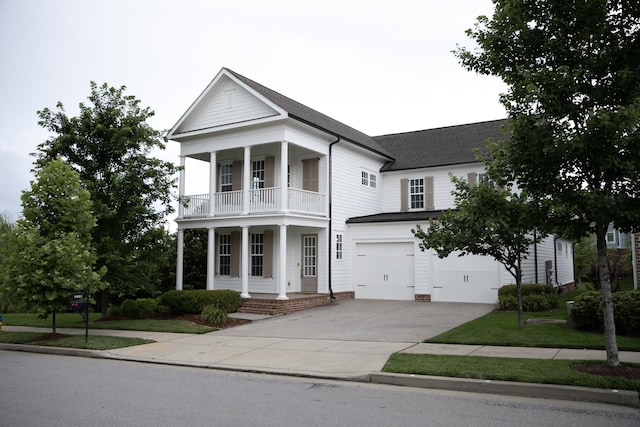 1023 Echelon Dr, Franklin, TN 37064 - neoclassical home featuring a balcony, concrete driveway, an attached garage, and a porch