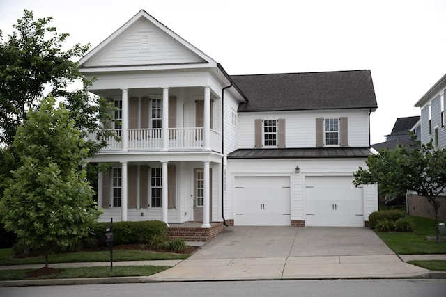 1023 Echelon Dr, Franklin, TN 37064 - greek revival house with a porch, a standing seam roof, concrete driveway, an attached garage, and a metal roof