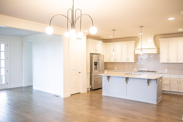 1023 Echelon Dr, Franklin, TN 37064 - kitchen featuring appliances with stainless steel finishes, backsplash, a breakfast bar, premium range hood, and dark wood-style flooring