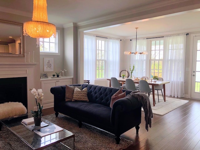 1023 Echelon Dr, Franklin, TN 37064 - living area with a chandelier, ornamental molding, wood finished floors, and a large fireplace