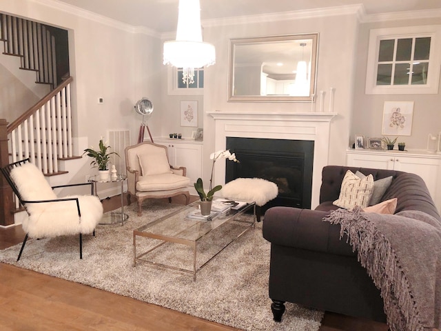 1023 Echelon Dr, Franklin, TN 37064 - living area with wood finished floors, crown molding, stairway, a fireplace, and a chandelier