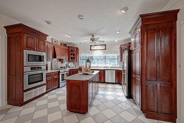 398 N Hummingbird Ln, Dickson, TN 37055 - kitchen with stainless steel appliances, a warming drawer, light countertops, ornamental molding, and a ceiling fan