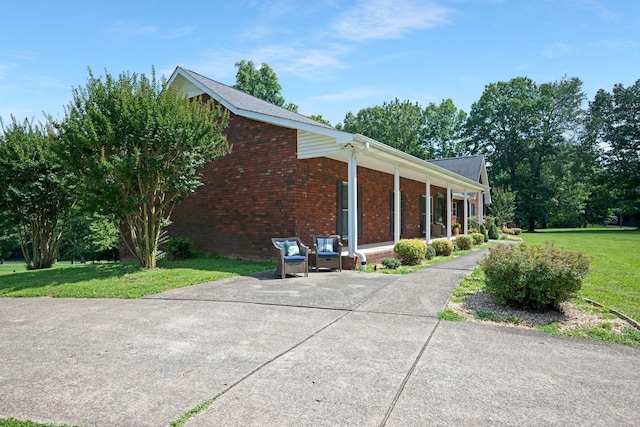 398 N Hummingbird Ln, Dickson, TN 37055 - view of side of property with brick siding and a lawn