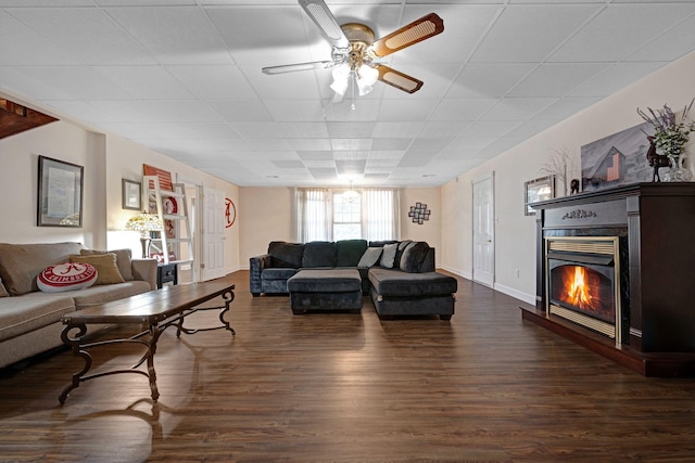 398 N Hummingbird Ln, Dickson, TN 37055 - living area featuring a glass covered fireplace, dark wood finished floors, a ceiling fan, and a drop ceiling