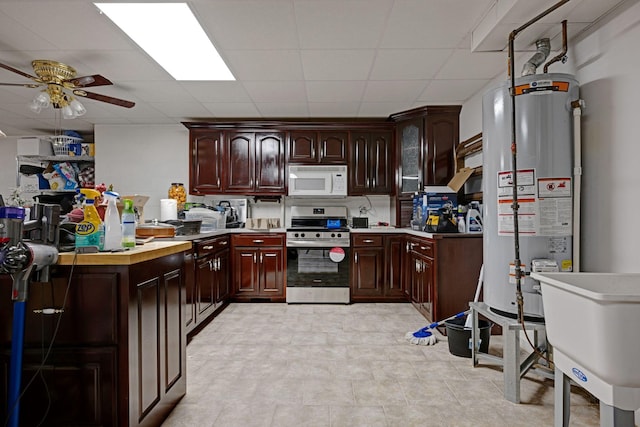 398 N Hummingbird Ln, Dickson, TN 37055 - kitchen with electric stove, water heater, white microwave, ceiling fan, and light countertops