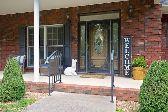 398 N Hummingbird Ln, Dickson, TN 37055 - view of exterior entry featuring covered porch and brick siding