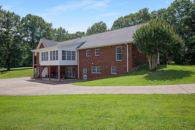 398 N Hummingbird Ln, Dickson, TN 37055 - back of property with stairs, a sunroom, a yard, a patio, and driveway