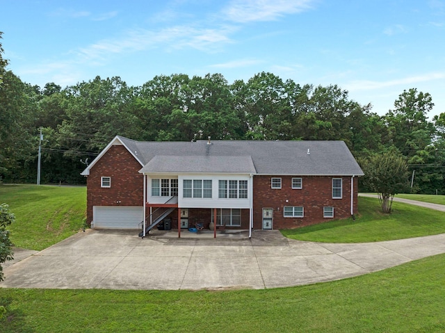 398 N Hummingbird Ln, Dickson, TN 37055 - back of property with brick siding, a garage, a lawn, driveway, and stairs