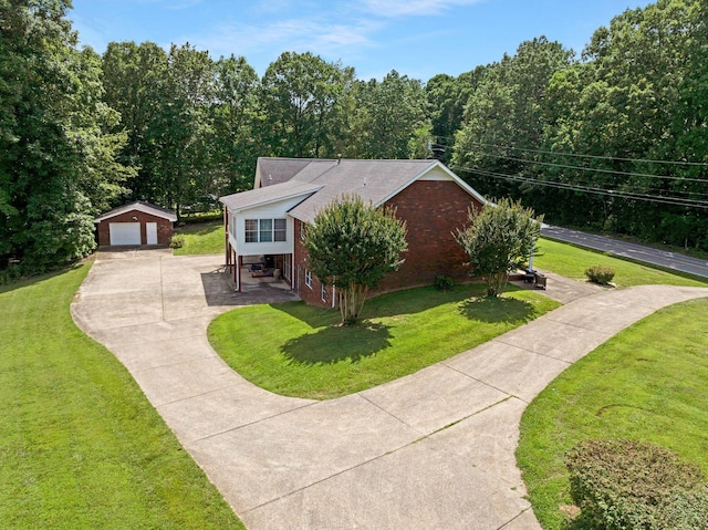 398 N Hummingbird Ln, Dickson, TN 37055 - view of front facade featuring a detached garage, an outdoor structure, a front yard, brick siding, and a shingled roof