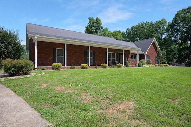 398 N Hummingbird Ln, Dickson, TN 37055 - ranch-style home with brick siding, covered porch, and a front lawn