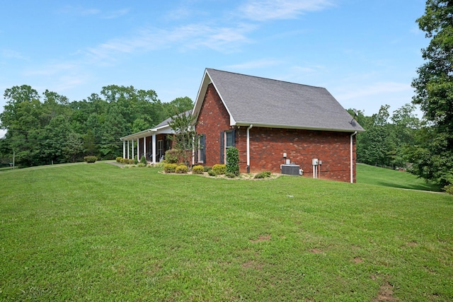 398 N Hummingbird Ln, Dickson, TN 37055 - view of side of property with a yard, brick siding, a shingled roof, and a sunroom