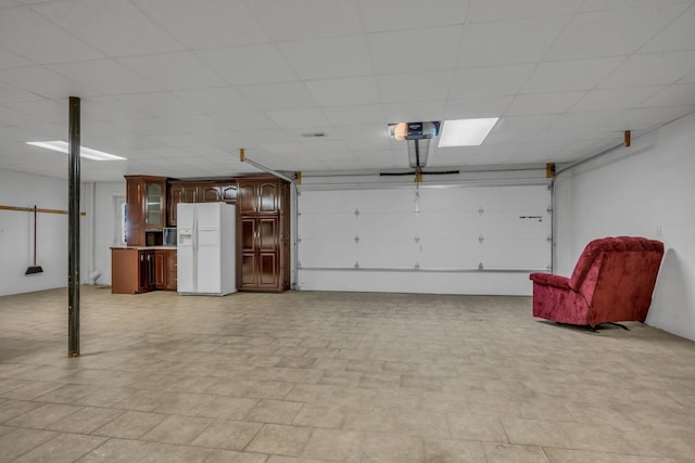 398 N Hummingbird Ln, Dickson, TN 37055 - garage featuring white refrigerator with ice dispenser and a garage door opener