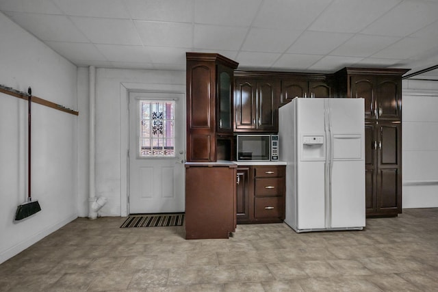 398 N Hummingbird Ln, Dickson, TN 37055 - kitchen with white fridge with ice dispenser, a paneled ceiling, dark brown cabinets, and light countertops
