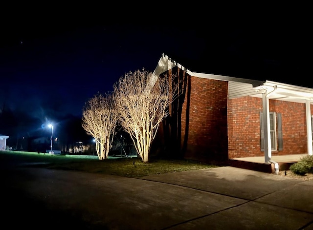 398 N Hummingbird Ln, Dickson, TN 37055 - property exterior at twilight with brick siding and a patio area