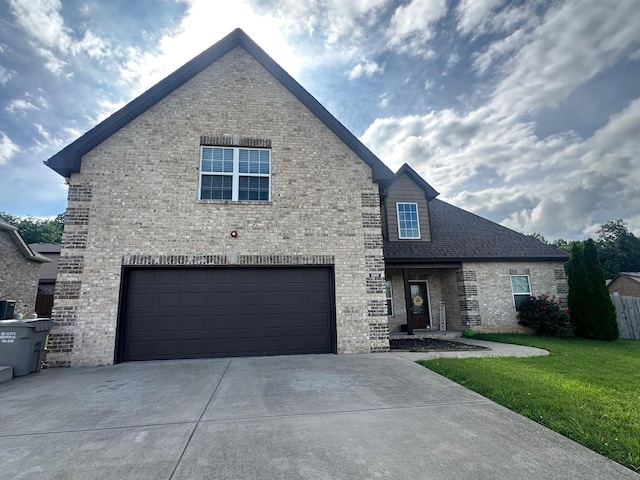 2009 Azalea Ct N, Ashland City, TN 37015 - view of front of property featuring driveway, a garage, brick siding, and a front yard