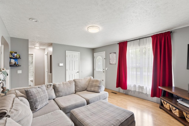 149 Cora St, Portland, TN 37148 - living area with wood finished floors, a textured ceiling, and arched walkways