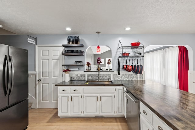 149 Cora St, Portland, TN 37148 - kitchen with stainless steel appliances, dark countertops, open shelves, white cabinets, and light wood-style flooring