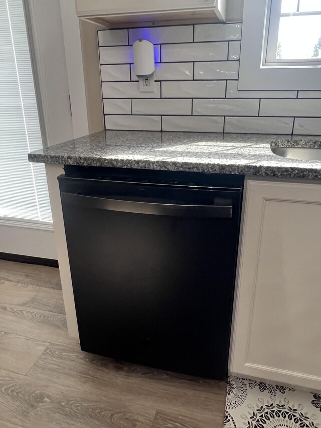 108 Chase Bend Rd, Estill Springs, TN 37330 - detailed view of dishwashing machine, backsplash, and wood finished floors