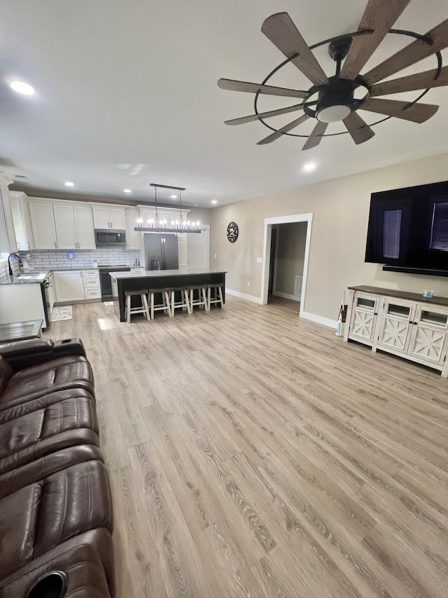 108 Chase Bend Rd, Estill Springs, TN 37330 - living room with recessed lighting, light wood-style floors, a ceiling fan, and a chandelier
