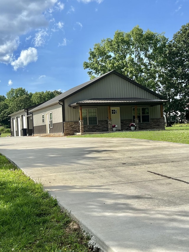 108 Chase Bend Rd, Estill Springs, TN 37330 - view of front facade with stone siding, concrete driveway, and covered porch