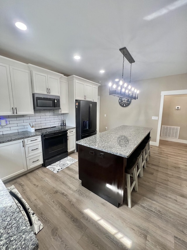 108 Chase Bend Rd, Estill Springs, TN 37330 - kitchen featuring black appliances, a kitchen island, white cabinets, backsplash, and recessed lighting